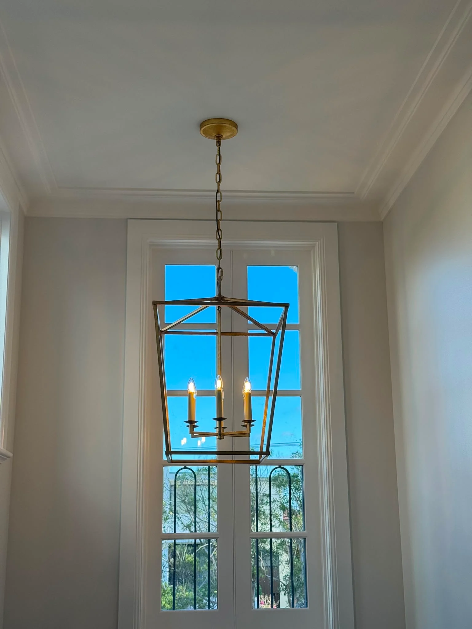 Gold lantern pendant in a double-height window void