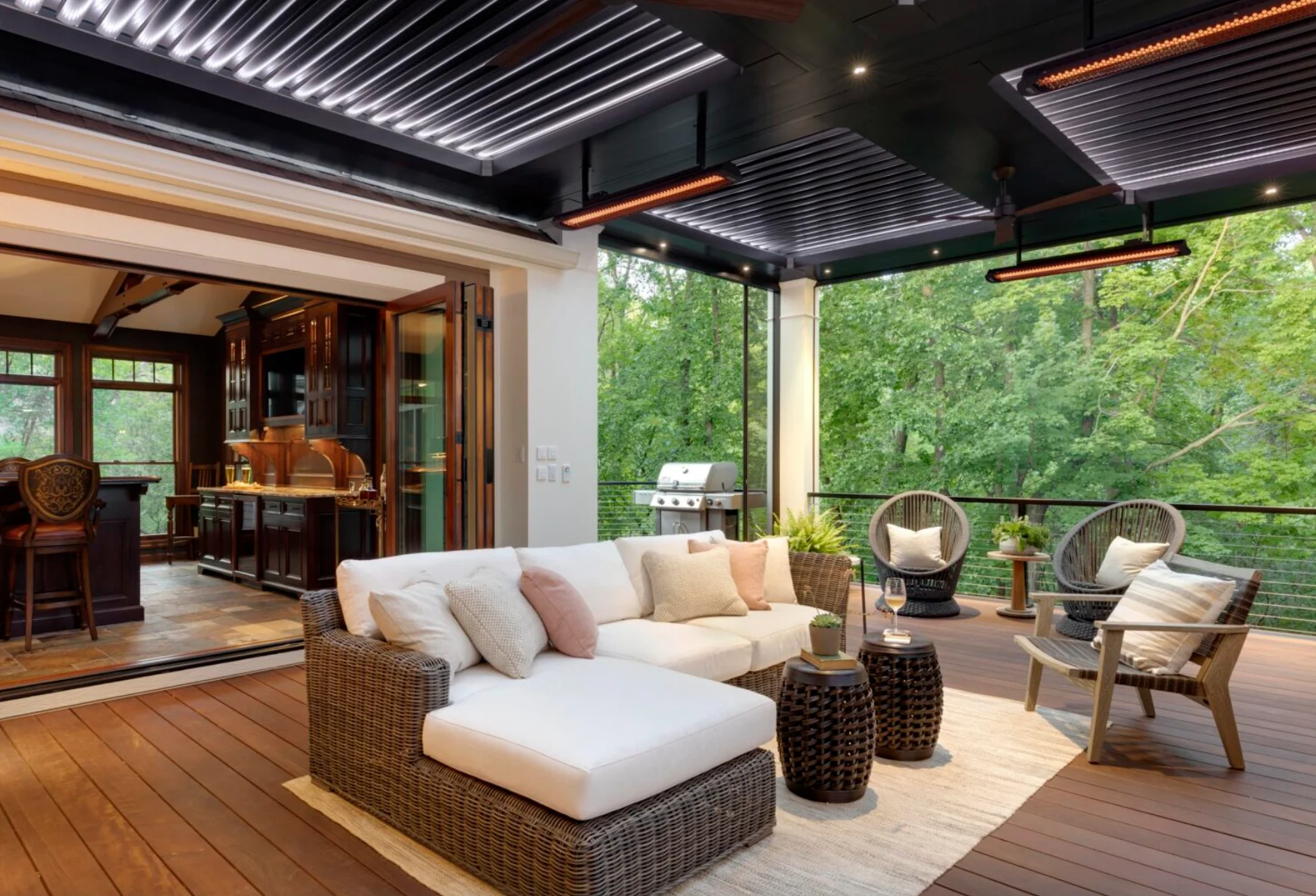 Covered alfresco deck with radiant strip heating and layered lighting